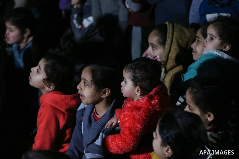 Palestinian children watch a movie during an event called "Cinema Camp" organised by Palestinian activists in al-Nusirat refugee camp in the central Gaza strip on January 27, 2020. Photo by Ashraf Amra
