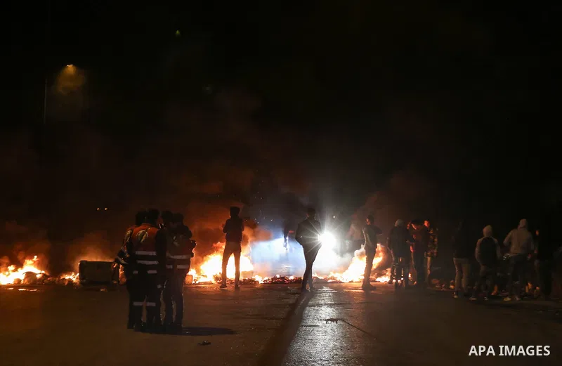 Palestinian demonstrators burn tyres during a protest against US President Donald Trump's Century Deal "expected peace plan" near the settlement of Beit El in the West Bank on January 28, 2020. Donald Trump has launched...