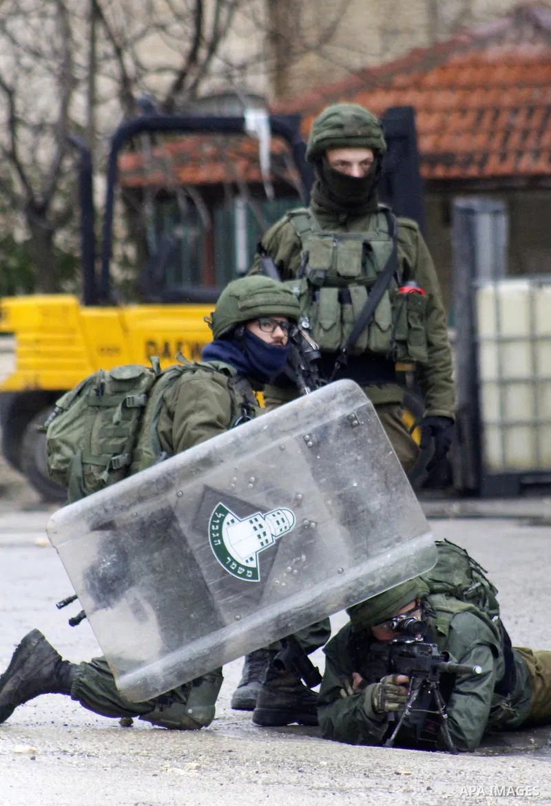 Israeli soldiers fire teargas towards Palestinian demonstrators during clashes against US President Donald Trump's expected peace plan proposal or Deal of the Century, in Arroub refugee camp north of the West Bank city o...