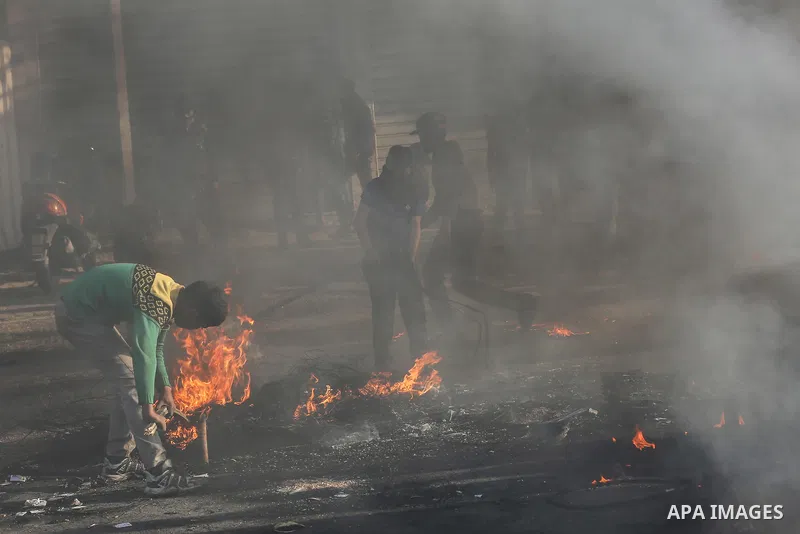 Palestinian demonstrators burn tyres during a protest against US President Donald Trump's Century Deal "expected peace plan" in Rafah in the southern Gaza Strip on January 29, 2020. Donald Trump has launched his “ultimat...