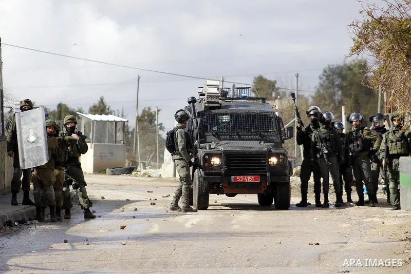 Israeli security forces take position during clashes with Palestinian protesters following a demonstration against US President Donald Trump's Century Deal "expected peace plan" in Arroub refugee camp north of the West B...