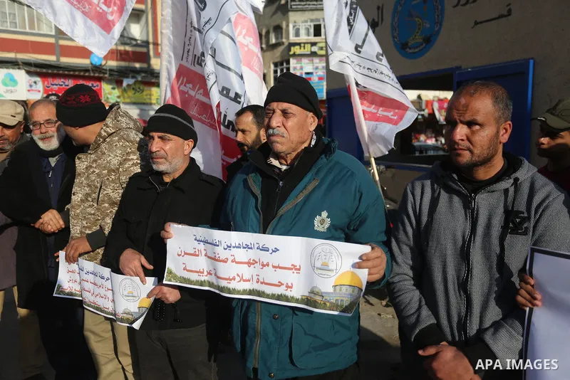 Palestinians protesters hold banners during protest against US President Donald Trump's Century Deal "expected peace plan" in Nuseirat in the center of Gaza Strip on February 1, 2020. Photo by Ashraf Amra
