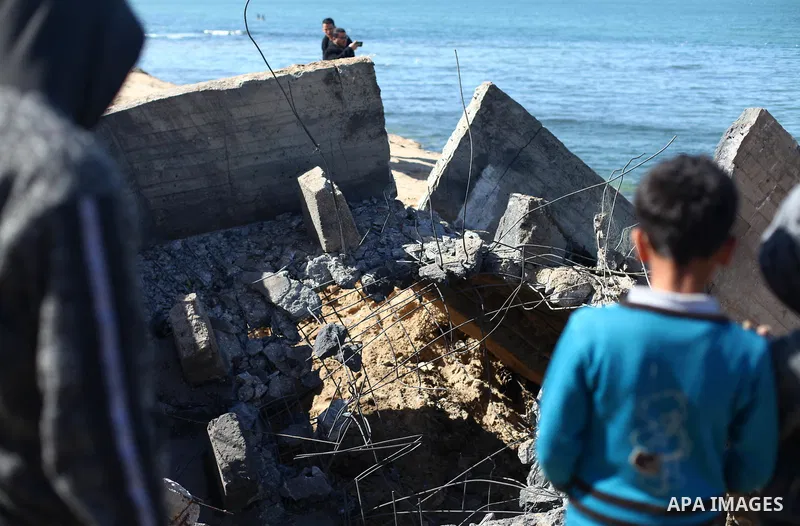 Palestinians look on the site of an Israeli airstrike at Al-Shatee refugee camp in Gaza City February 6, 2020. Israeli aircraft struck Hamas positions in Gaza early Thursday, the military said, after Palestinians in the...