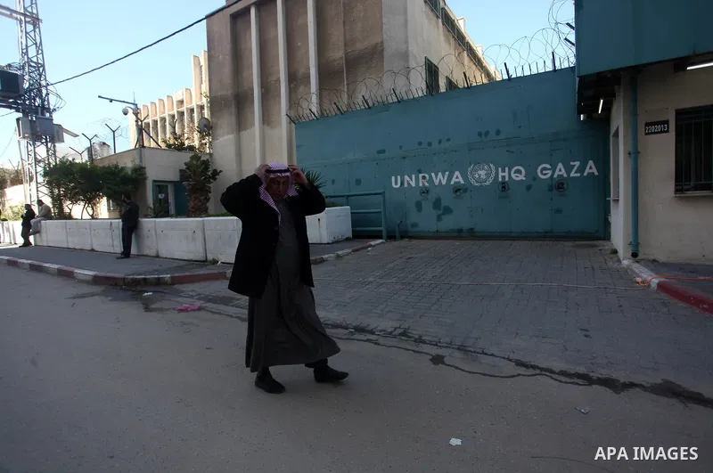 A Palestinian man walks past the headquarters United Nations Relief and Works Agency (UNRWA) in Gaza city, on February 13, 2020. Photo by Mahmoud Ajjour