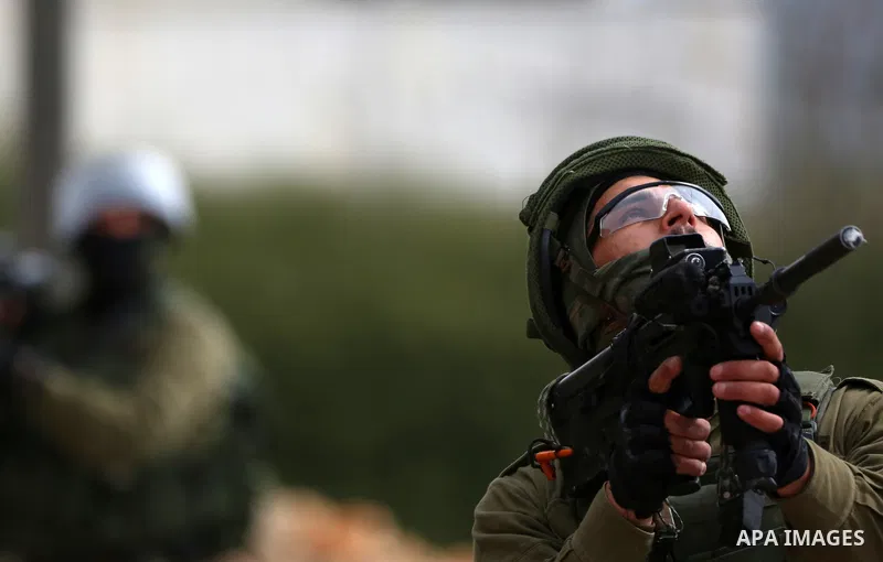 Israeli security forces take position during clashes with Palestinian protesters following a weekly demonstration against the expropriation of Palestinian land by Israel in the village of Kfar Qaddum, near the West Bank...