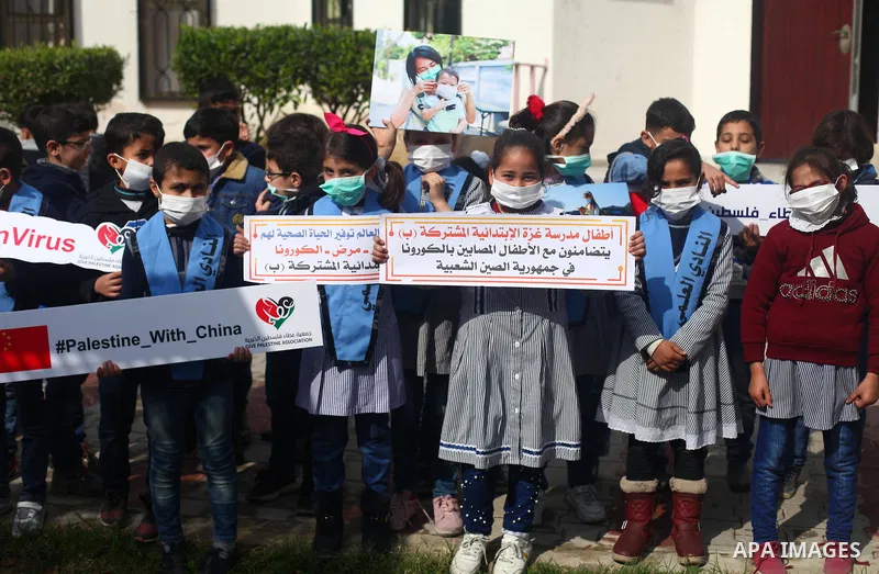 Palestinian childern take part in a rally to support with people in China suffering from the Corona virus, in Gaza city, on February 16, 2020. China has more than 80 running or pending clinical trials on potential treatm...