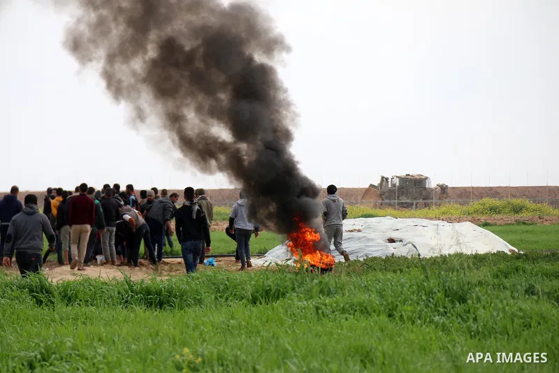Palestinian protesters burn tires at the Israel-Gaza border east of Khan Yunis in the southern Gaza Strip, on February 23, 2020. Israeli troops opened gunfire at Palestinian civilians and injured two of them, as they wer...