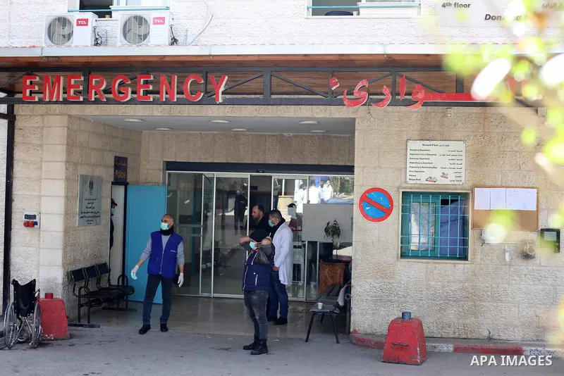 A Palestinian man wearing a mask as a preventive measure against the coronavirus stands outside Beit Jala governmental hospital, in the West Bank city of Bethlehem on March 05, 2020. The Palestinian health ministry calle...