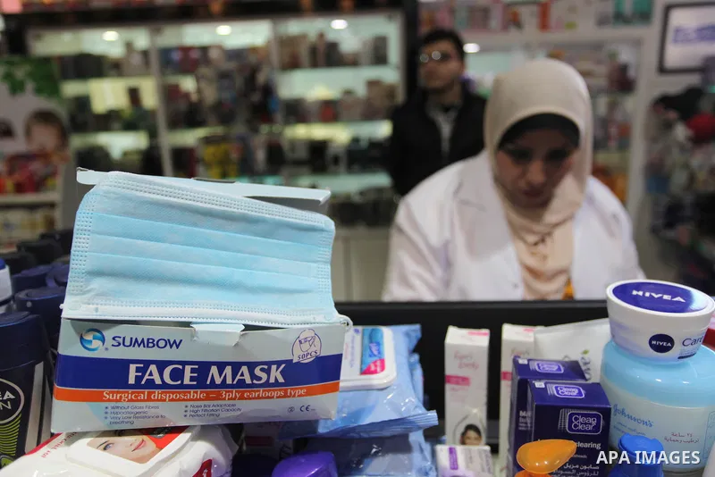 A Palestinian pharmacist, sells face masks during a safety campaign to spread awareness about COVID-19 coronavirus disease, at a pharmacy in Gaza city, on March 7, 2020. Photo by Mahmoud Ajjour