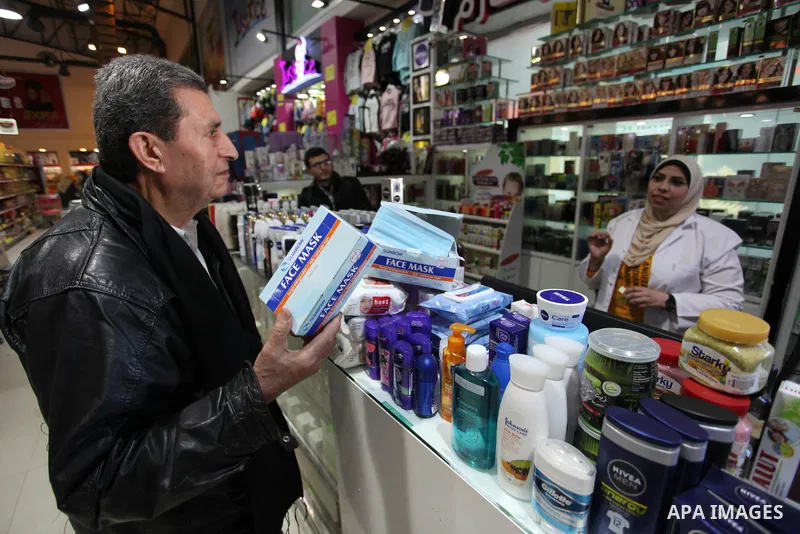 A Palestinian pharmacist, sells face masks during a safety campaign to spread awareness about COVID-19 coronavirus disease, at a pharmacy in Gaza city, on March 7, 2020. Photo by Mahmoud Ajjour