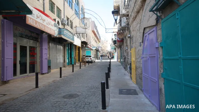 Palestinians walk on a street, after preventive measures are taken against the coronavirus, in the West Bank city of Bethlehem on March 08, 2020. The Palestinian government announced a month-long state of emergency after...