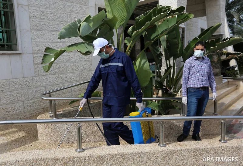 A Palestinian worker disinfects a municipal building, as a preventive measure amid fears of the spread of the novel coronavirus, in Khan Younis in the southern Gaza Strip on March 9, 2020. Photo by Ashraf Amra