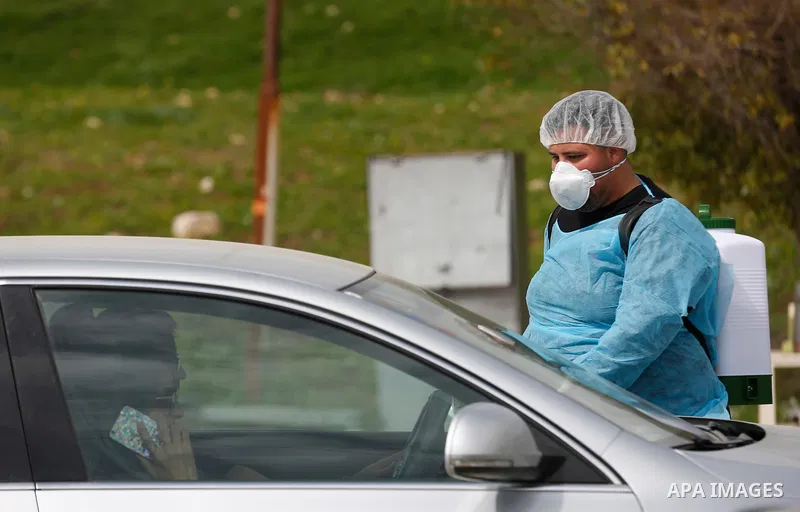 Palestinian workers disinfect cars on the streets, as a preventive measure amid fears of the spread of the novel coronavirus, in the West Bank city of Nablus, on March 10, 2020. Photo by Shadi Jarar'ah