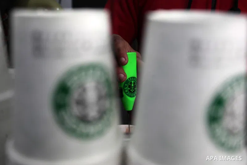 Palestinian Mohammed al-Nimr, 21, sells hot drinks on his Starbucks cart, in Gaza City on March 11, 2020. Starbucks Corporation is an American coffee company and coffeehouse chain. Starbucks was founded in Seattle, Washi...