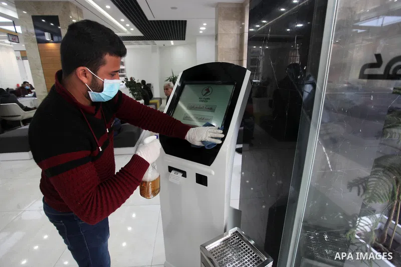 A Palestinian worker disinfects a Electricity Company, as a preventive measure amid fears of the spread of the novel coronavirus in Gaza city, on March 12, 2020. Photo by Mahmoud Ajjour