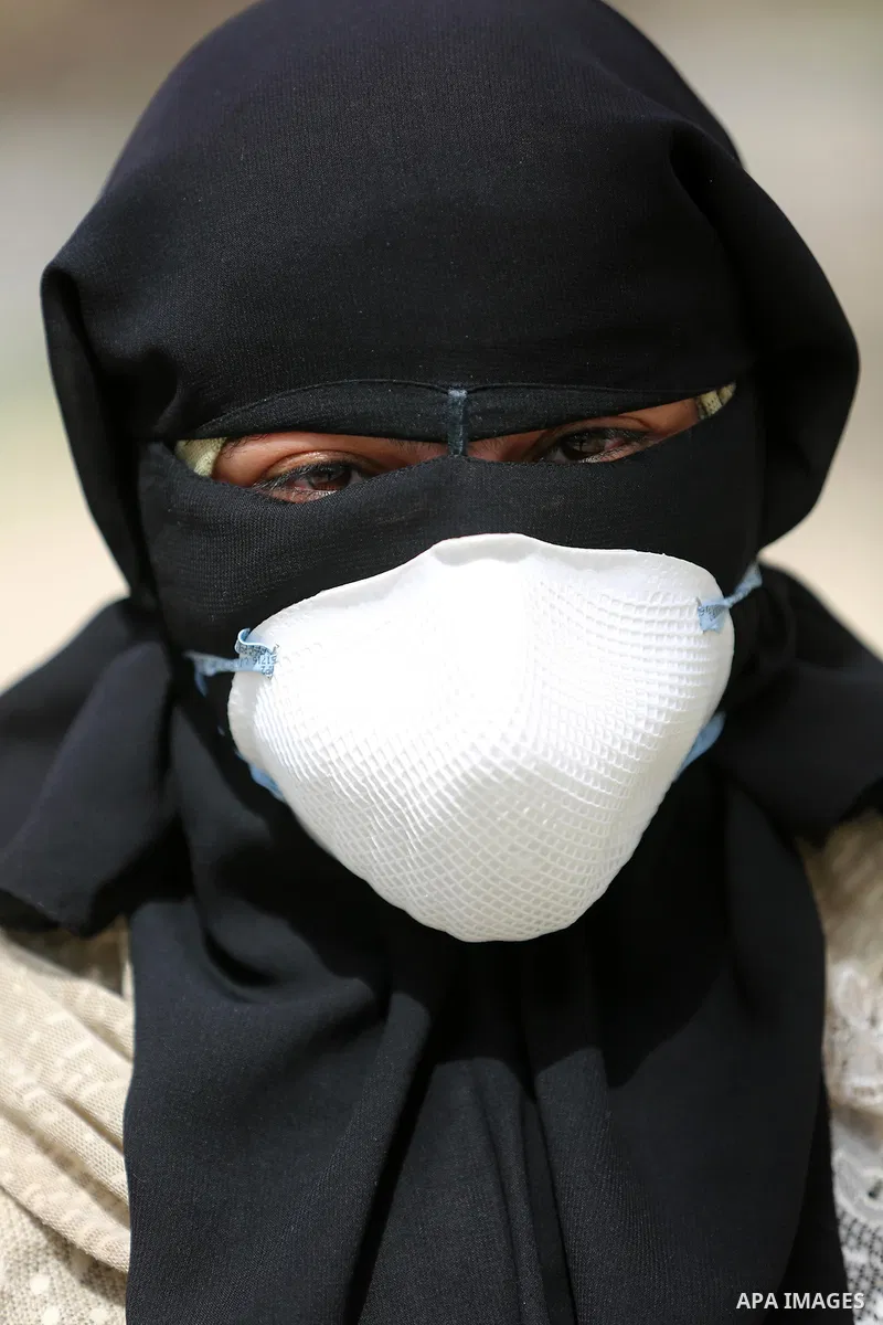 A Palestinian health worker wearing a protective mask walks in a quarantine zone installed by the ministry of health to test passengers for coronavirus, at Rafah border crossing in the southern Gaza Strip on March 12, 20...