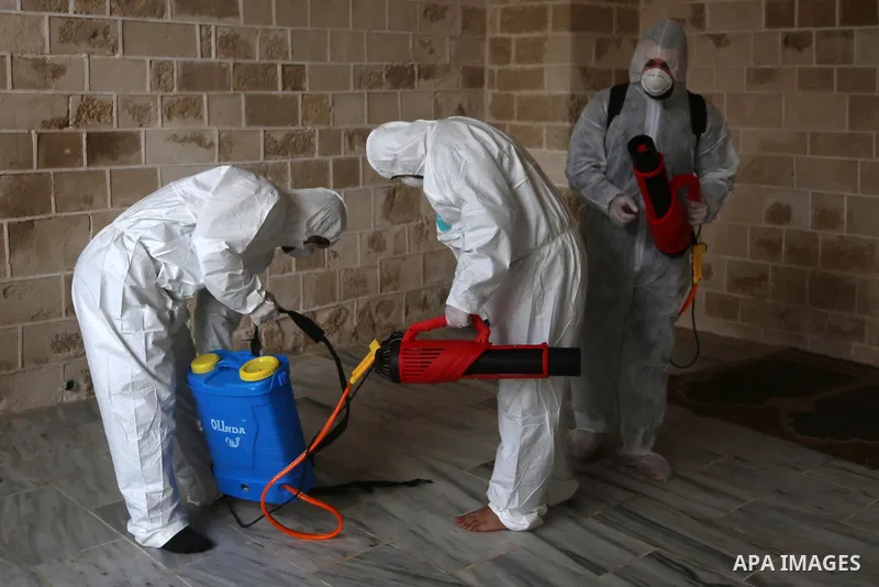 Palestinian workers disinfect Al-Omari Mosque, as a preventive measure amid fears of the spread of the novel coronavirus, in Gaza City on March 12, 2020. Photo by Ashraf Amra
