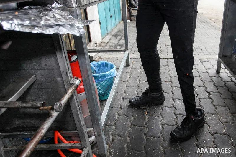 Palestinian wounded Adham Al-Tahrawi, who lost his leg after shotting him by Israeli forces during the weekly border protests, sells shawarma in a restaurant in Gaza City, March 13, 2020. The Palestinian Day of the Wound...