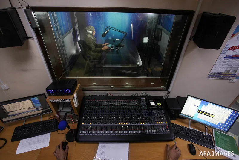 A Palestinian teacher broadcasts an electronic lesson on the Education radio, during school students vacation as a preventive measure amid fears of the spread of the novel coronavirus, in Gaza city, on March 15, 2020. Ph...