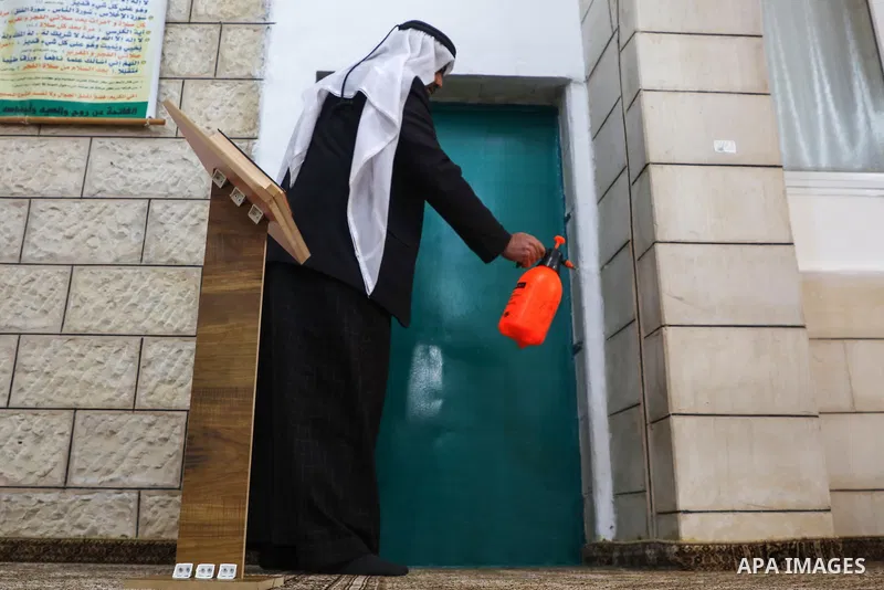 A Palestinian worker disinfect the mosque as a preventive measure amid fears of the spread of the novel coronavirus in the West Bank city of Jenin on March 15, 2020. For most people, the new coronavirus causes only mild...
