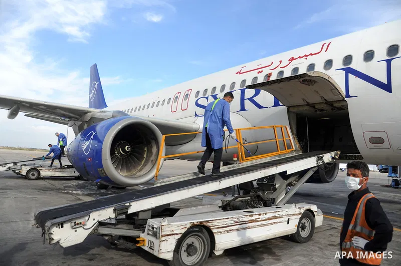 Syrian workers wearing protective gear, disinfects aircraft at Damascus International Airport as a preventive measure amid fears of the spread of the coronavirus COVID-19, in Damascus, Syria, on March 16, 2020. Even thou...