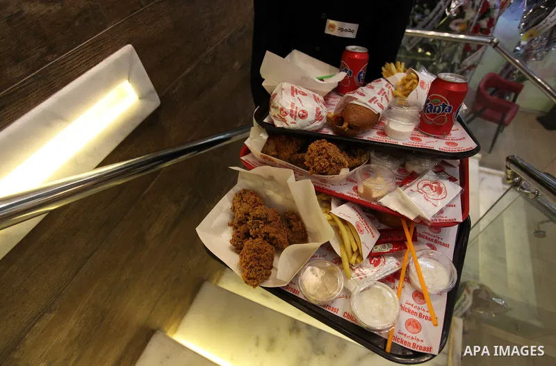 Palestinian youth serve the fast food for customers, at the Chicken Broast in Gaza City, on March 16, 2020. Chicken Broast is a restaurant located in Egypt, serving a selection of Sandwiches that delivers across Miami -...