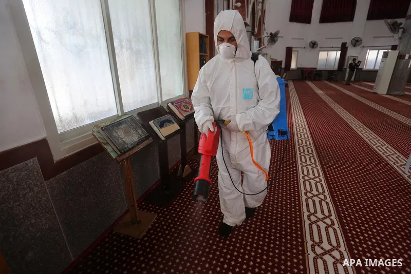 A Palestinian worker disinfects a Mosque, as a preventive measure amid fears of the spread of the novel coronavirus, in Khan Younis in the southern of Gaza strip, on March 16, 2020. Photo by Ashraf Amra
