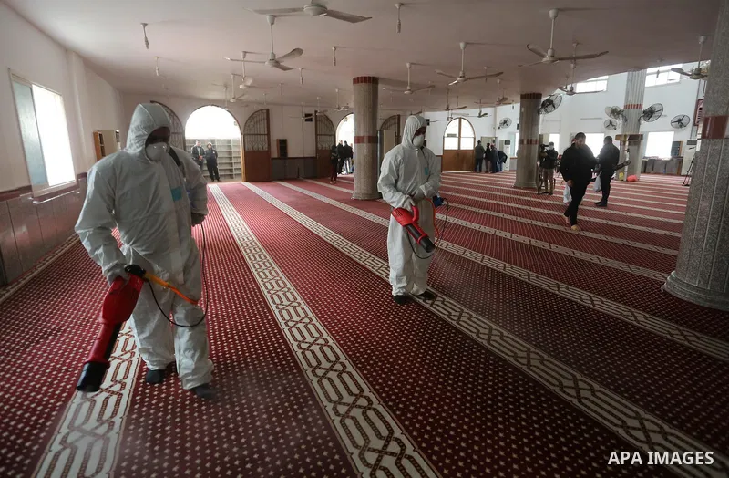 Palestinian workers disinfect a Mosque, as a preventive measure amid fears of the spread of the novel coronavirus, in Khan Younis in the southern of Gaza strip, on March 16, 2020. Photo by Ashraf Amra