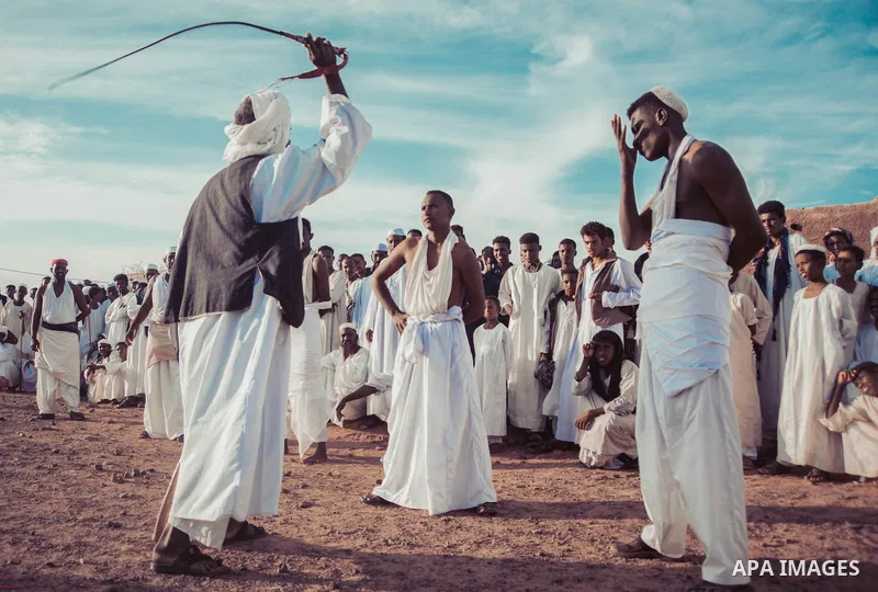 Sudanese take part in a heritage party In the city of Shendi in northern Sudan on February 24, 2020. The lash of the guests is usually one of the customs and traditions of the Ja’alin tribe in Sudan, and they have pride...