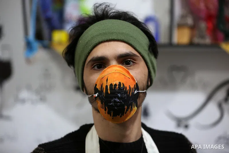 Palestinian artists Samah Said and Dorgham Krakeh paint N95 protective masks for a project raising awareness about the coronavirus COVID-19, in Gaza City on March 25, 2020. Production of face masks in factories has incre...