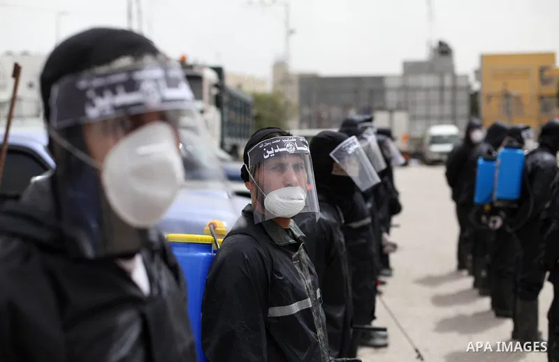 Members of al-Mujahideen brigades, the military wing of al-Mujahideen movement, spray disinfectant as a preventive measure amid fears of the spread of the coronavirus, in Gaza city, on March 31, 2020. Photo by Mahmoud Aj...