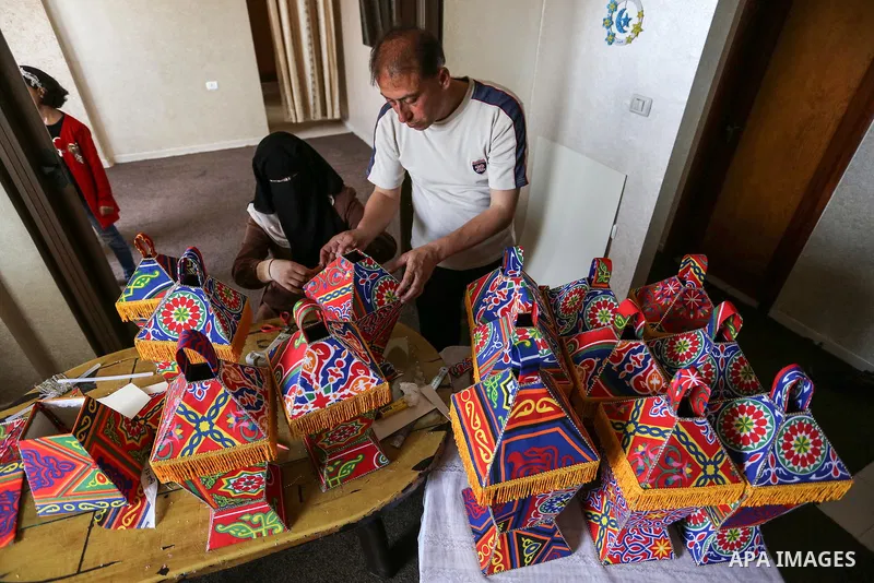 Palestinian Muhammad al-Yaqoubi, his wife and children make lanterns for sale in preparation for the Muslim holy month of Ramadan, as they confine themselves to their home amid concerns about the spread of the coronaviru...