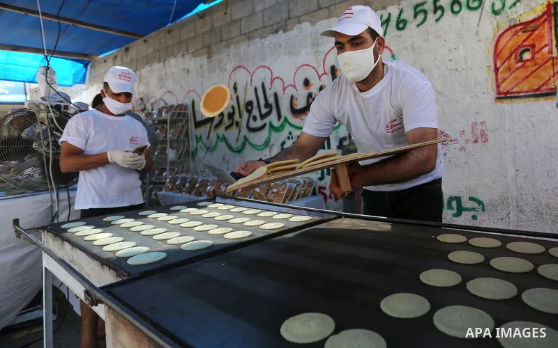 Palestinian vendors wearing protective face masks prepare ''Qatayef'', traditional pancakes that are popular during the Muslim fasting month of Ramadan in Gaza city, on April 28, 2020. Muslims around the world celebrate...