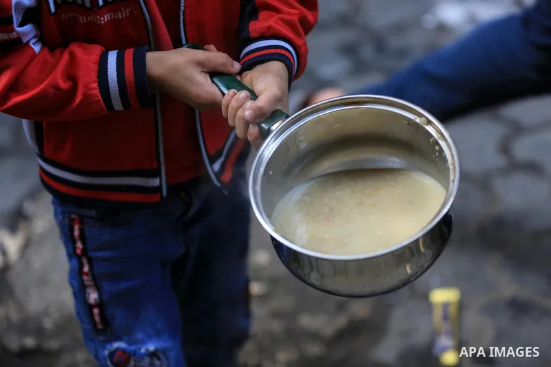 A Palestinian man distributes free food during the holy fasting month of Ramadan, amid concerns about the spread of the coronavirus disease (COVID-19), in al-Shijaiyah neighborhood, in Gaza city on April 28, 2020. Muslim...