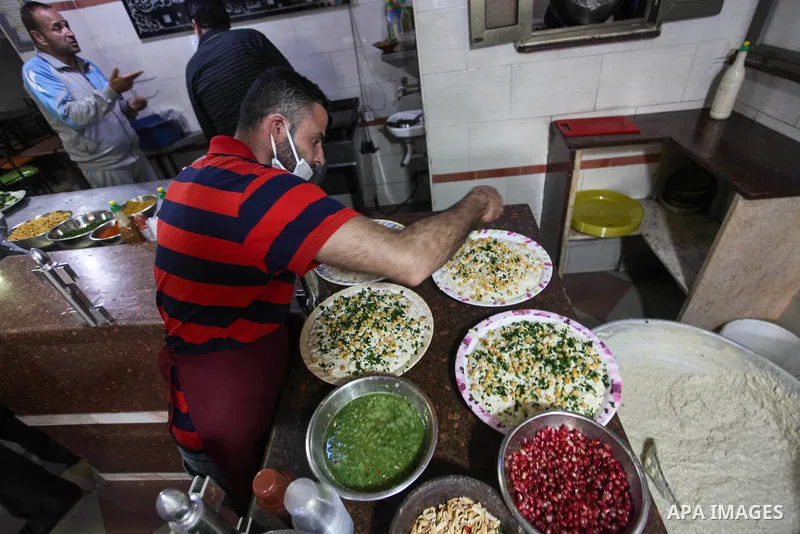 A Palestinian vendor prepares chickpeas known as "Hummus" for breakfasting on the Muslim holy fasting month of Ramadan in Gaza city, on April 29, 2020. Muslims around the world celebrate the holy month of Ramadan by pray...