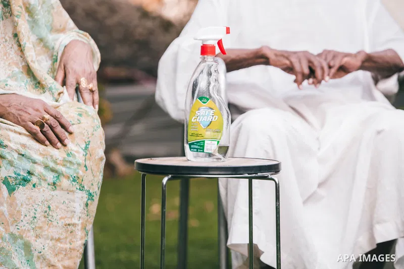 Sudanese woman sprays disinfectant at the hands of her husband, as a precaution against the spread of the coronavirus disease (COVID-19) in Khartoum, Sudan on May 05, 2020. Photo by faiz Abu bakr