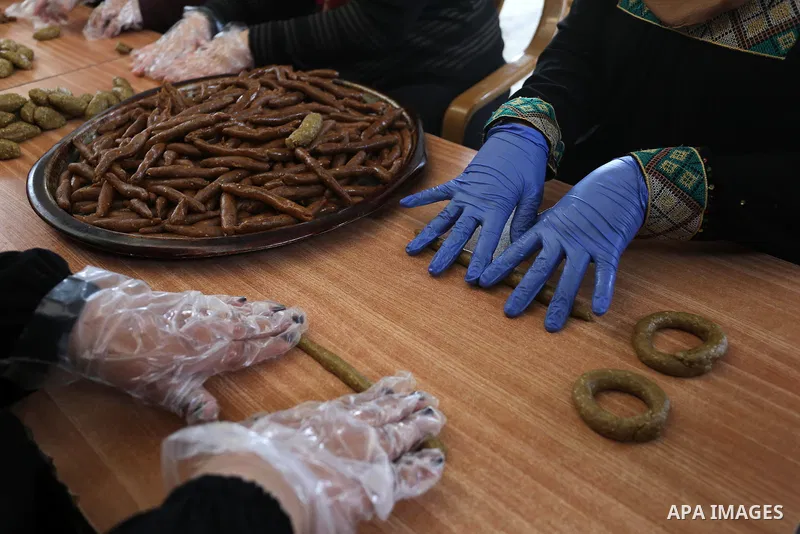Palestinians prepare traditional cookies for distribution to poor families, ahead of the Eid al-Fitr festivities, celebrating the end of the holy Muslim fasting month of Ramadan, in Rafah in the southern of Gaza strip, o...
