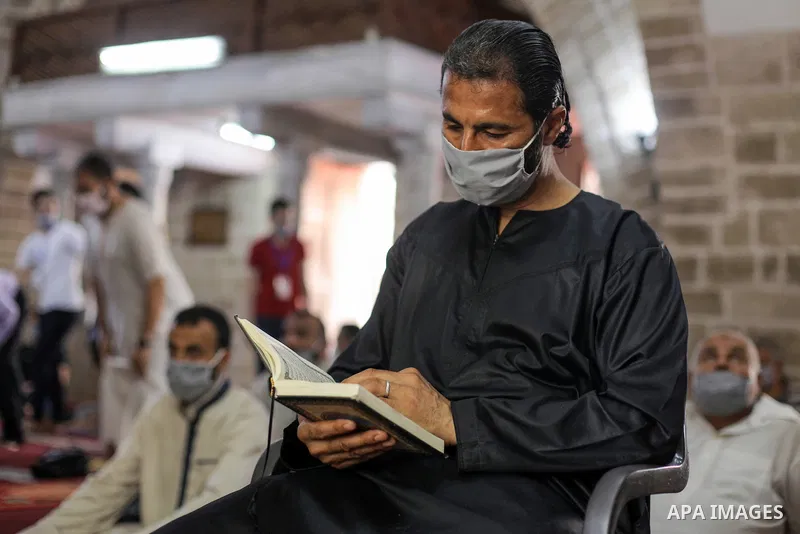 Palestinians wearing masks attend Friday prayers in a mosque as the holy places reopen to worshippers to perform the weekly Islamic ritual, amid concern about the spread of the coronavirus disease (COVID-19), in Gaza Cit...