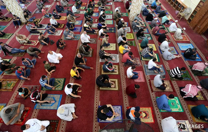 Palestinians wearing masks attend Friday prayers in a mosque as the holy places reopen to worshippers to perform the weekly Islamic ritual, amid concern about the spread of the coronavirus disease (COVID-19), in Khan You...