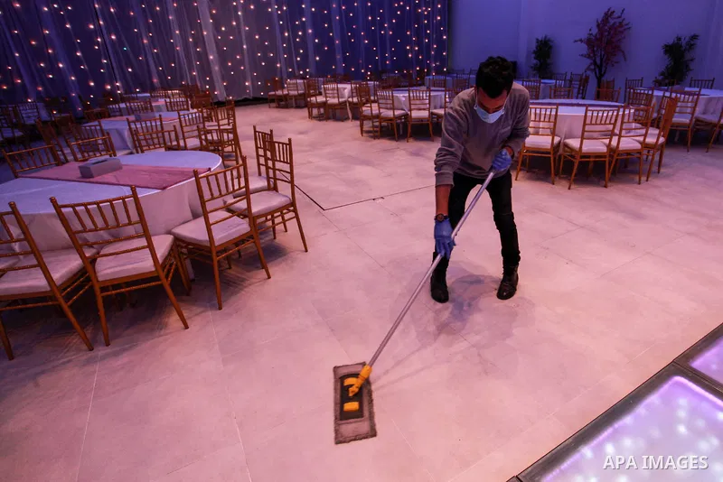 Palestinian workers disinfect the wedding hall, as a preventive measure amid fears of the spread of the novel coronavirus in Gaza City on June 3, 2020. Photo by Mahmoud Ajjour