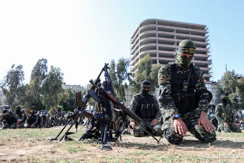Palestinian militants from the Al-Quds Brigades, the armed wing of the Islamic Jihad movement, pray ahead of a military parade during a condolences ceremony for the movement's former leader Ramadan Shalah in Gaza city, o...