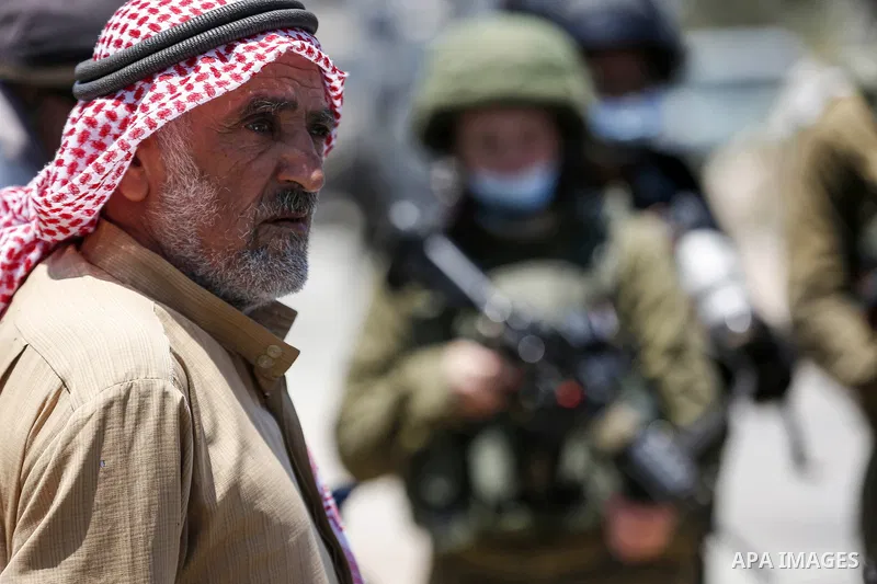 Palestinian protester stands during a protest against Israel's plan to annex parts of the occupied West Bank, in the Palestinian village of Haris, southwest of Nablus, on June 26, 2020. Photo by Shadi Jarar'ah