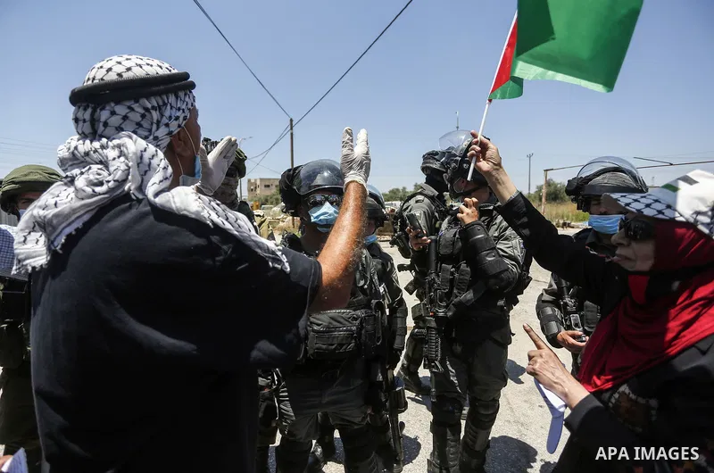 Palestinians argue with Israeli security forces during a protest against Israel's plan to annex parts of the occupied West Bank, in the Palestinian village of Haris, southwest of Nablus, on June 26, 2020. Photo by Shadi...