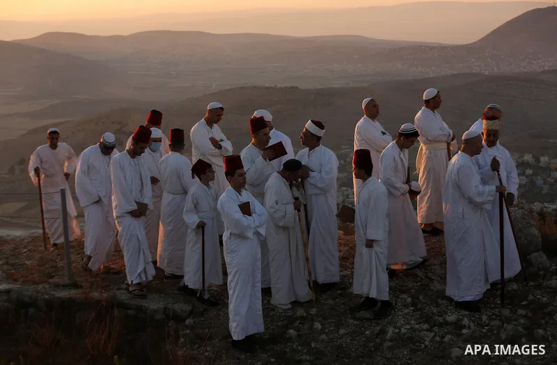 Samaritans gather to pray on top of Mount Gerizim near the northern West Bank city of Nablus as they celebrate the Shavuot festival at dawn, on June 28, 2020. Shavuot marks the giving of the Torah at Mount Sinai seven we...