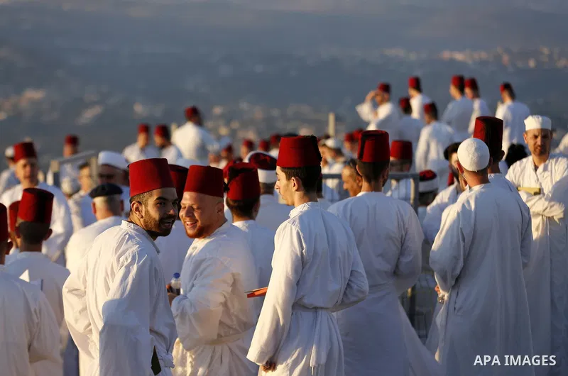 Samaritans gather to pray on top of Mount Gerizim near the northern West Bank city of Nablus as they celebrate the Shavuot festival at dawn, on June 28, 2020. Shavuot marks the giving of the Torah at Mount Sinai seven we...