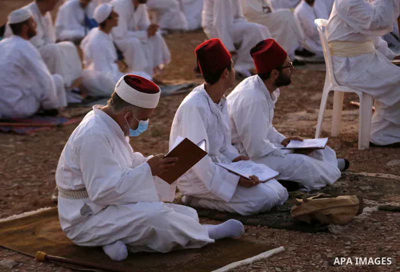 Samaritans gather to pray on top of Mount Gerizim near the northern West Bank city of Nablus as they celebrate the Shavuot festival at dawn, on June 28, 2020. Shavuot marks the giving of the Torah at Mount Sinai seven we...