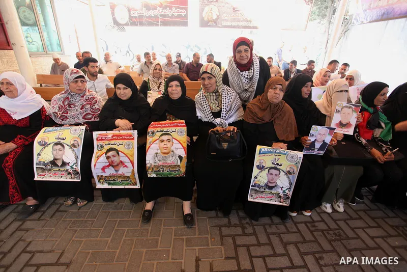 Palestinians take part in a protest in solidarity with prisoners in Israeli jails, in front of the Red cross office, in Gaza city on June 29, 2020. Photo by Mahmoud Ajjour