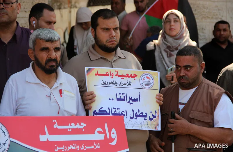 Palestinians take part in a protest in solidarity with prisoners in Israeli jails, in front of the Red cross office, in Gaza city on June 29, 2020. Photo by Mahmoud Ajjour