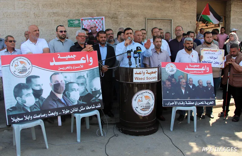 Palestinians take part in a protest in solidarity with prisoners in Israeli jails, in front of the Red cross office, in Gaza city on June 29, 2020. Photo by Mahmoud Ajjour