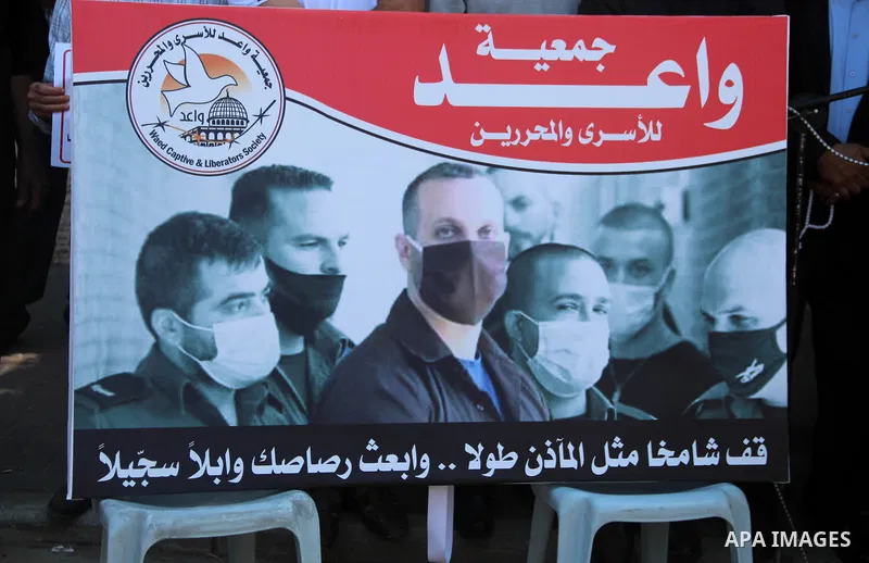 Palestinians take part in a protest in solidarity with prisoners in Israeli jails, in front of the Red cross office, in Gaza city on June 29, 2020. Photo by Mahmoud Ajjour